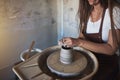 Creative artisan shaping clay on a wheel in her studio