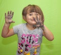 Creative Girl with Paint on her Hands makes a mess with painted hands in front of a Green Screen