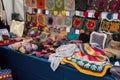 creative and artistic display of handmade crafts, including crocheted blankets, embroidered pillows, and knitted scarves