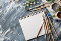 A Creative Artistic Workspace Featuring a Blank Sketchbook, Paintbrushes, and More Royalty Free Stock Photo