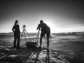 Creative artists stay at own cameras on tripods. Hikers and enthusiasts