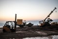 Abstract Industrial background with construction crane silhouette over amazing sunset sky. Mobile crane against the evening sky. Royalty Free Stock Photo