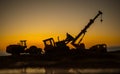 Abstract Industrial background with construction crane silhouette over amazing sunset sky. Mobile crane against the evening sky. Royalty Free Stock Photo