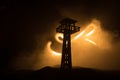 Creative artwork decoration. Silhouette of army watchtower at night. Selective focus