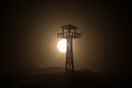 Creative artwork decoration. Silhouette of army watchtower at night. Selective focus