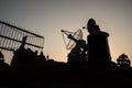 Creative artwork decoration. Silhouette of mobile air defence truck with radar antenna during sunset. Satellite dishes or radio