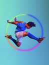 Creative artwork of prfessional male football player in motion over neon geometric element over blue background