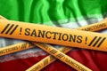 Creative background, inscription on the flag of Iran, sanctions, yellow fencing tape. The concept of sanctions, policies,