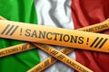 Creative background, the inscription on the flag of Italy, sanctions, yellow protective tape. The concept of sanctions, policies,