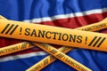 Creative background, the inscription on the flag of North Korea, sanctions, yellow fencing tape. The concept of sanctions,