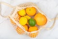 Creative background made of summer tropical fruits with grapefruit, orange, tangerine, lemon, lime on white marble background.