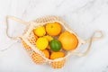 Creative background made of summer tropical fruits with grapefruit, orange, tangerine, lemon, lime on white marble background.