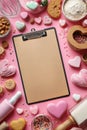 Creative Baking Preparation With Heart-Shaped Treats and a Clipboard on a Pink Background Royalty Free Stock Photo