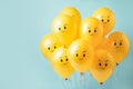 Creative banner with yellow balloons with angry unhappy faces con blue background. Social issues self-identity business teamwork