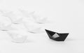 Creative black paper ship among white. concept leadership
