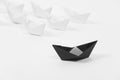 Creative black paper ship among white. concept leadership