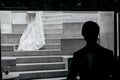 Creative black white photo with stylish groom posing and bride wedding dress on stairs in hotel room Royalty Free Stock Photo