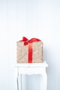 bright photo minimalism, gift box on a white wall background. Gift and Presentation Symbol, New Year, Valentine`s Day,