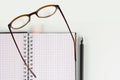 Creative business accessories - notebook, pen, glasses. Top view Royalty Free Stock Photo