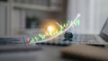 Creative business idea development with light bulb symbolizing innovation, laptop with financial chart showcasing growth Royalty Free Stock Photo