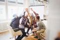 Creative business people giving high-five in meeting room Royalty Free Stock Photo