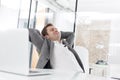 Creative businessman resting at desk in office