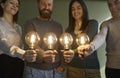 Creative business team with electric light bulbs illustrating concept of idea and innovation Royalty Free Stock Photo