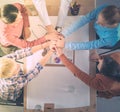 Creative business team putting hands together at the office Royalty Free Stock Photo