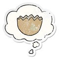 A creative cartoon cracked eggshell and thought bubble as a distressed worn sticker Royalty Free Stock Photo