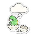 A creative cartoon dinosaur hatching and thought bubble as a distressed worn sticker Royalty Free Stock Photo