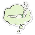 A creative cartoon marijuana joint and thought bubble as a distressed worn sticker Royalty Free Stock Photo