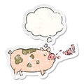 A creative cartoon oinking pig and thought bubble as a distressed worn sticker