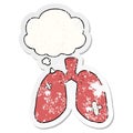 A creative cartoon repaired lungs and thought bubble as a distressed worn sticker