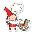 A creative cartoon santa making toy and thought bubble as a printed sticker