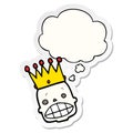 A creative cartoon spooky skull face with crown and thought bubble as a printed sticker