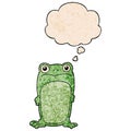 A creative cartoon staring frog and thought bubble in grunge texture pattern style