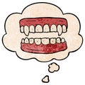 A creative cartoon vampire teeth and thought bubble in grunge texture pattern style Royalty Free Stock Photo