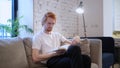 Creative Casual Man Reading Book, Sitting on Sofa