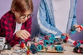 Creative caucasian children interestedly look robotics in studio