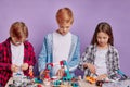 Creative caucasian children interestedly look robotics in studio
