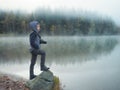 Creative child, kid photographer a little boy with a camera taking landscape pictures near la lake Royalty Free Stock Photo