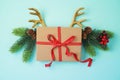 Creative Christmas background with gift box and reindeer horns Royalty Free Stock Photo