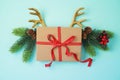 Creative Christmas background with gift box and reindeer horns