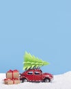 Creative Christmas background with toy car Volkswagen Beetleand pillow of snow