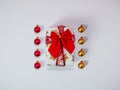 Creative Christmas composition made of gift box with red ribbon and baubles, christmas decorations, gold and red, flat lay, top vi Royalty Free Stock Photo