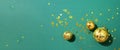 Creative Christmas concept. Shiny gold disco balls over green background. Flat lay, top view. New year baubles, star sparkles. Royalty Free Stock Photo