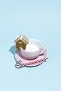 Creative Christmas layout with cup, ginger house and candy cane on blue pastel color background Royalty Free Stock Photo