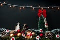 Creative Christmas and New Year composition made of Christmas tree and decorations with christmas light hanging on wall, pine cone