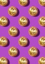 Creative Christmas pattern. Shiny gold disco balls over violet background. Flat lay, top view. New year baubles with shining Royalty Free Stock Photo