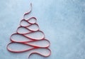 Creative Christmas tree made from red ribbon on blue background Royalty Free Stock Photo